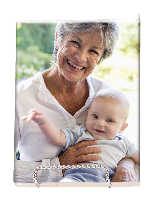 A custom ceramic tile with a matte finish, displaying a printed photo of an older woman holding a young child.